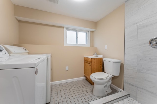 laundry area with washing machine and dryer and light tile patterned flooring