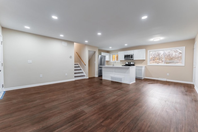 unfurnished living room with dark hardwood / wood-style floors