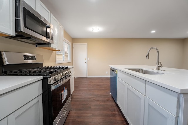 kitchen featuring dark hardwood / wood-style floors, white cabinetry, sink, and appliances with stainless steel finishes