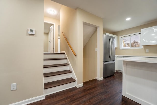 staircase featuring wood-type flooring