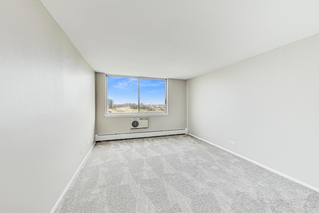 carpeted empty room featuring a baseboard heating unit