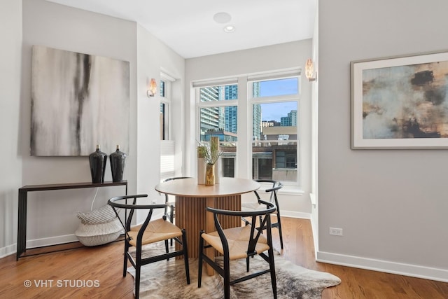 dining room with a wealth of natural light and hardwood / wood-style flooring