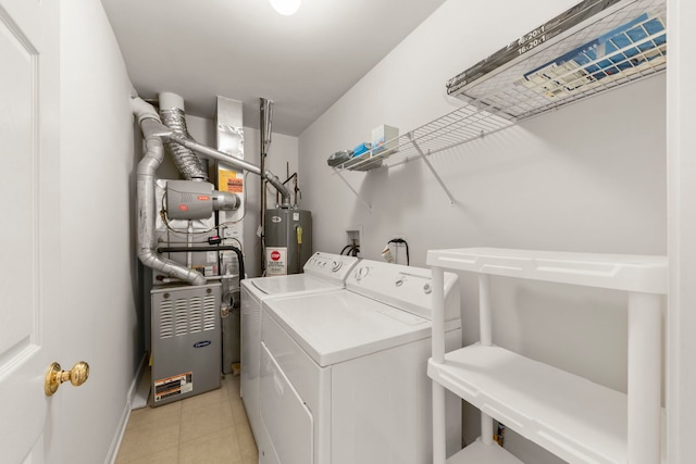 clothes washing area with washer and dryer and water heater