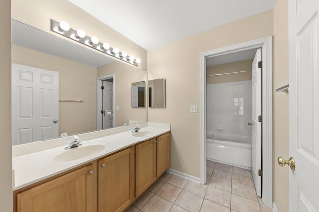 bathroom featuring tile patterned flooring, vanity, and tiled shower / bath combo