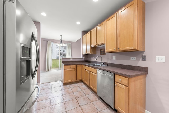 kitchen featuring sink, hanging light fixtures, a chandelier, light tile patterned flooring, and appliances with stainless steel finishes