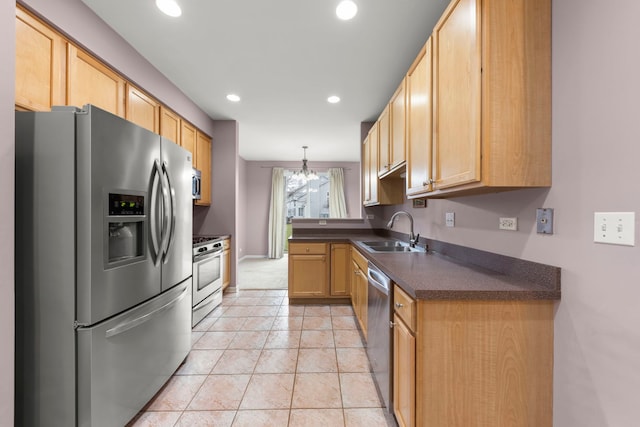 kitchen with sink, light brown cabinets, hanging light fixtures, an inviting chandelier, and appliances with stainless steel finishes