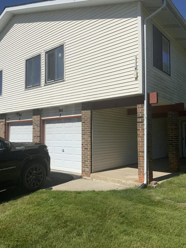 view of property exterior featuring a garage and a yard