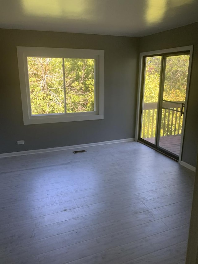 spare room featuring light hardwood / wood-style floors