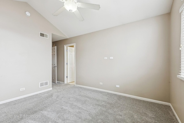 carpeted empty room featuring lofted ceiling and ceiling fan