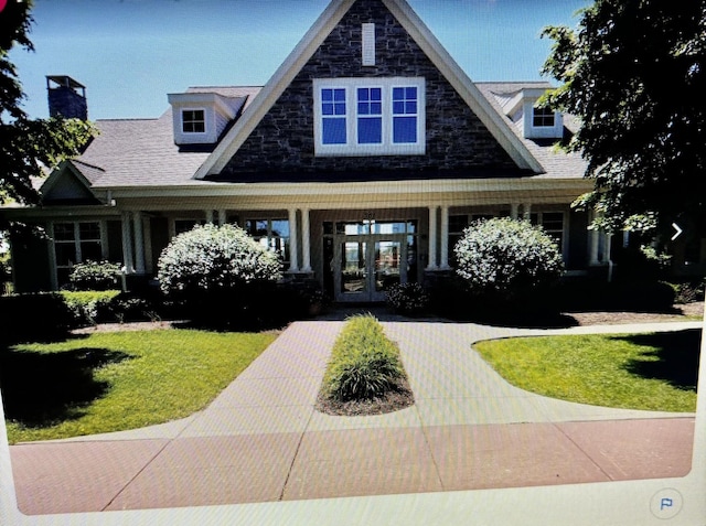 view of front of home with a front yard and french doors