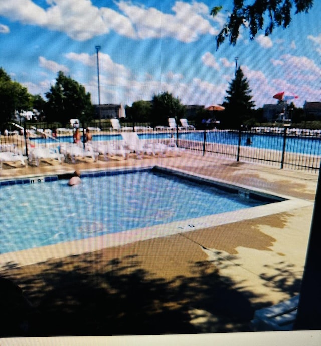 view of swimming pool with a patio area