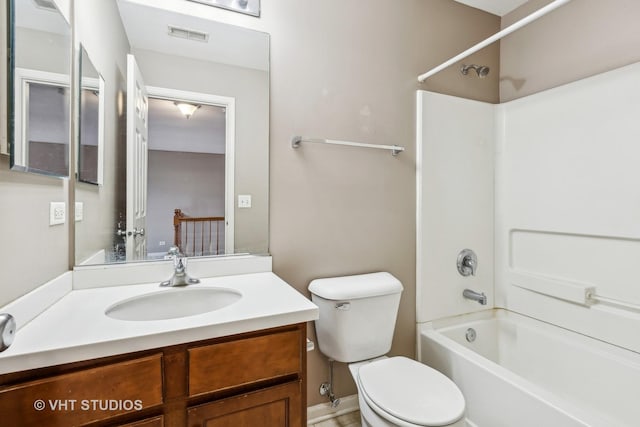 full bathroom with toilet, vanity, and washtub / shower combination