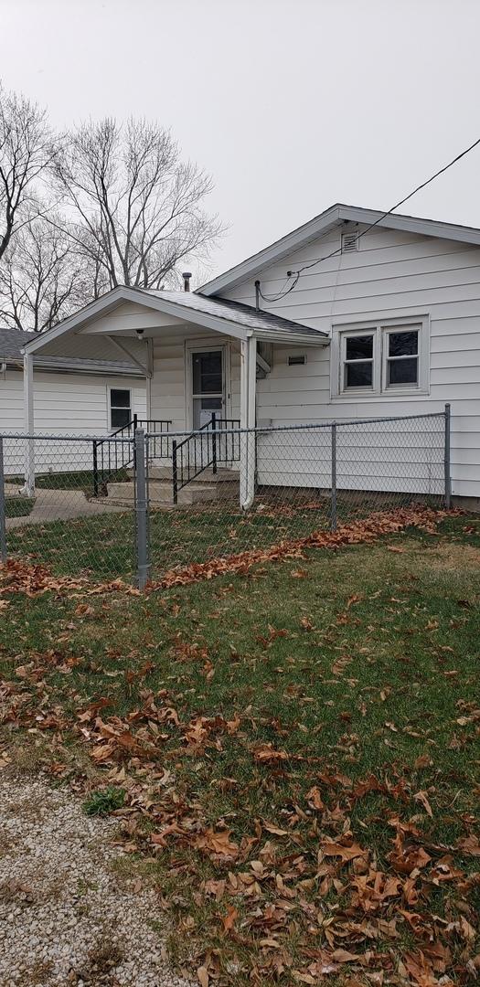 rear view of house featuring a yard