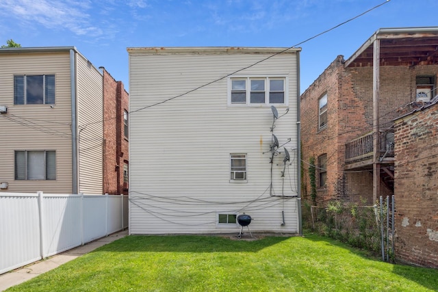 rear view of property with a lawn