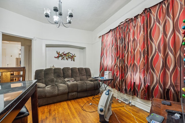 living room featuring hardwood / wood-style floors and a notable chandelier