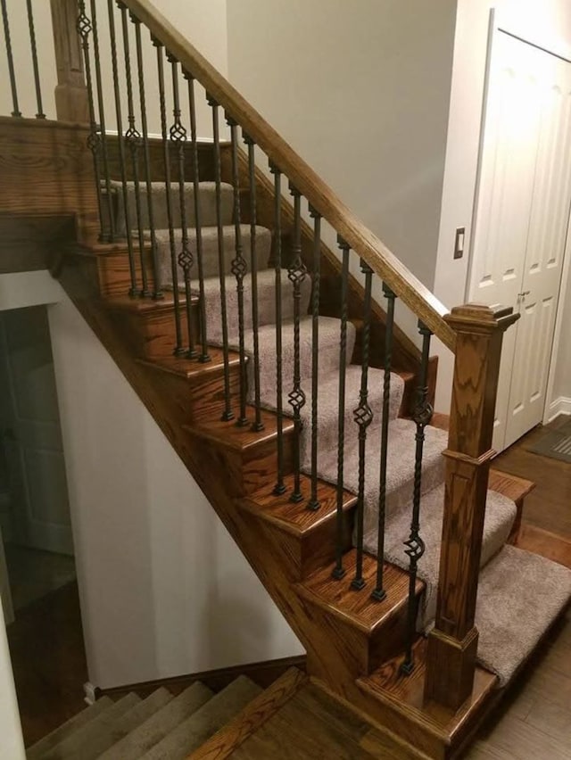 stairs with hardwood / wood-style floors