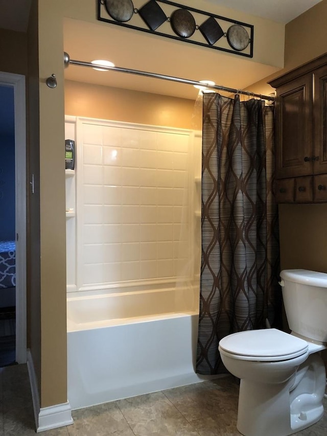 bathroom featuring shower / tub combo and toilet