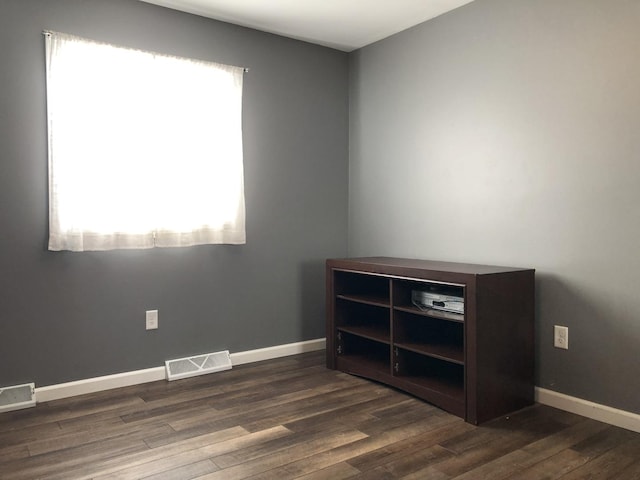 empty room with dark wood-type flooring