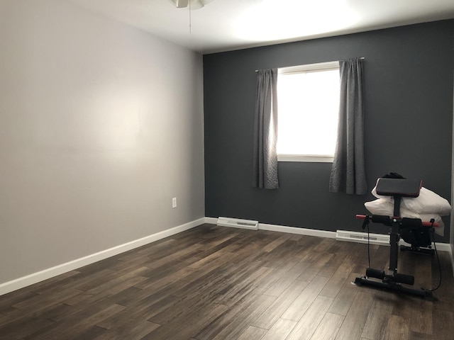 unfurnished room featuring dark wood-type flooring