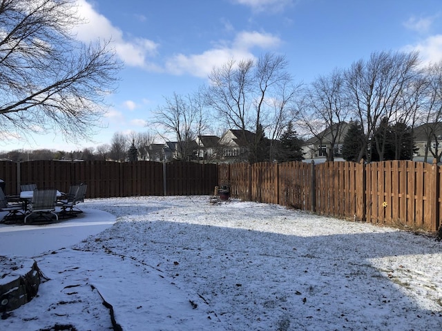 view of yard layered in snow