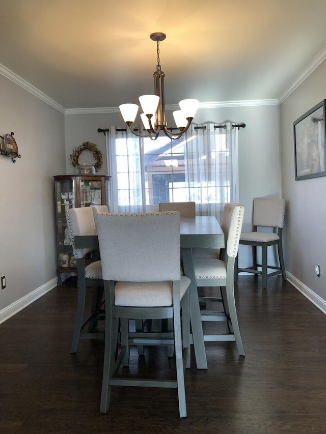 dining area with crown molding, dark hardwood / wood-style floors, and an inviting chandelier