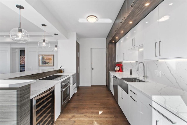 kitchen with white cabinets, sink, wine cooler, appliances with stainless steel finishes, and decorative light fixtures