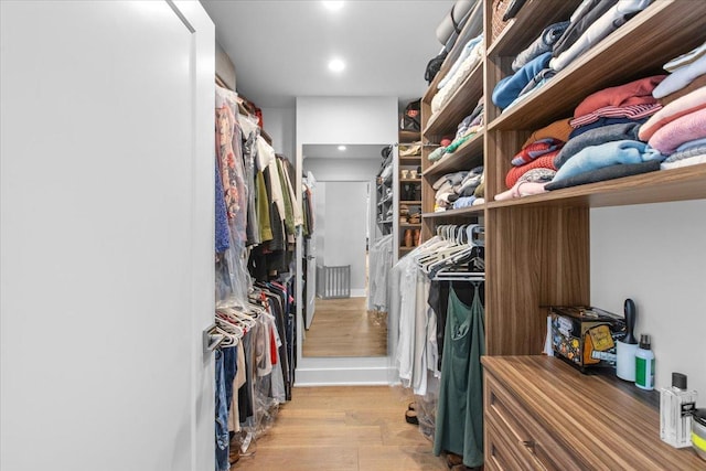 walk in closet featuring light hardwood / wood-style floors