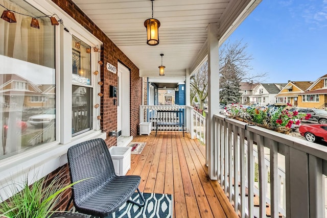 wooden terrace featuring covered porch