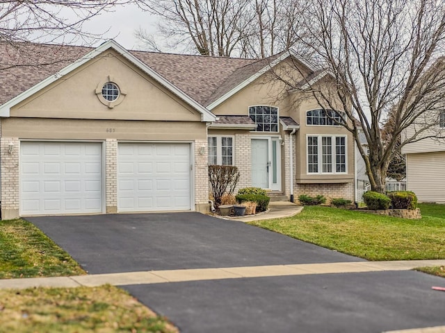 view of front of house with a front yard and a garage