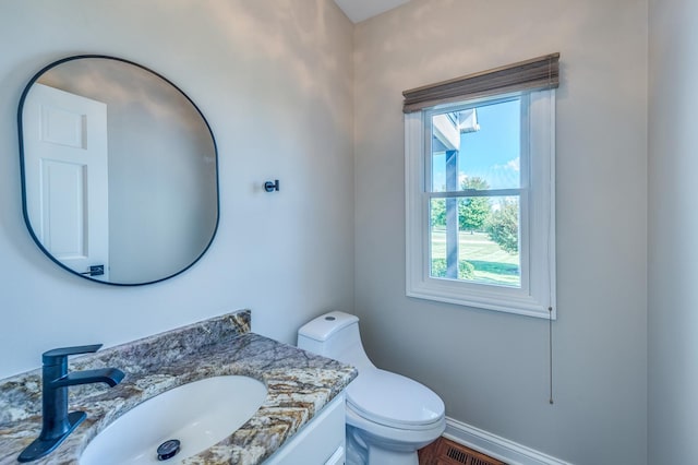 bathroom featuring vanity and toilet