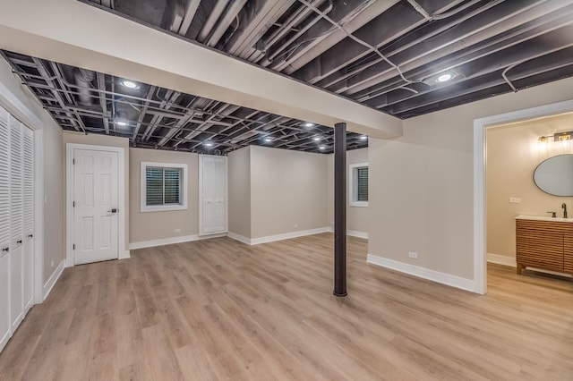 basement with light hardwood / wood-style floors