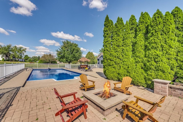 view of pool featuring a patio area and a fire pit