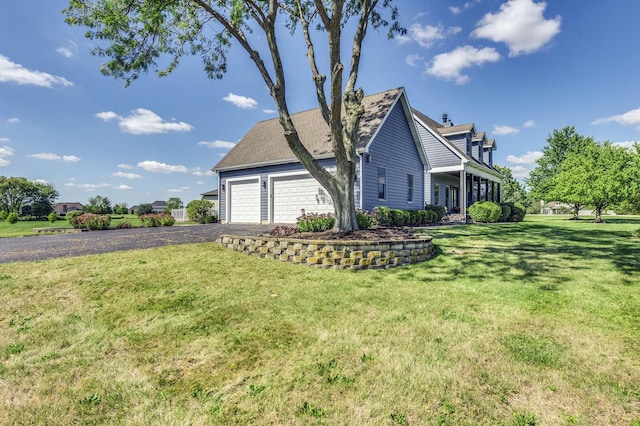 view of side of property with a garage and a lawn