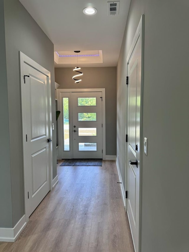 doorway to outside with light wood-type flooring