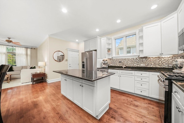 kitchen with ceiling fan, dark stone countertops, white cabinetry, and appliances with stainless steel finishes