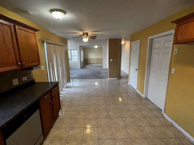 kitchen featuring ceiling fan, light tile patterned floors, and stainless steel dishwasher