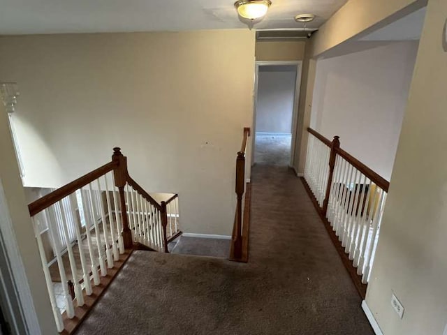 corridor featuring dark colored carpet