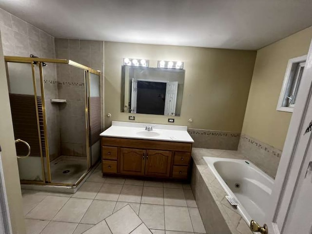 bathroom featuring plus walk in shower, vanity, and tile patterned floors