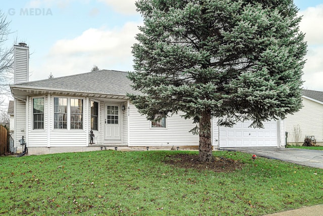 view of front of house with a front yard and a garage