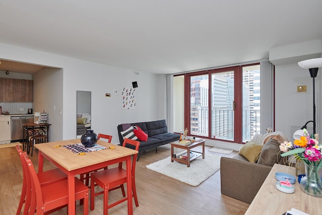 living room featuring floor to ceiling windows and light hardwood / wood-style flooring