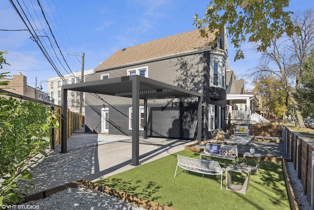 back of property with a lawn and a carport