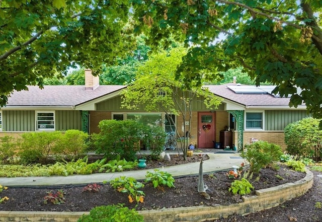 single story home featuring solar panels