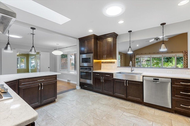 kitchen featuring hanging light fixtures, stainless steel appliances, plenty of natural light, and sink