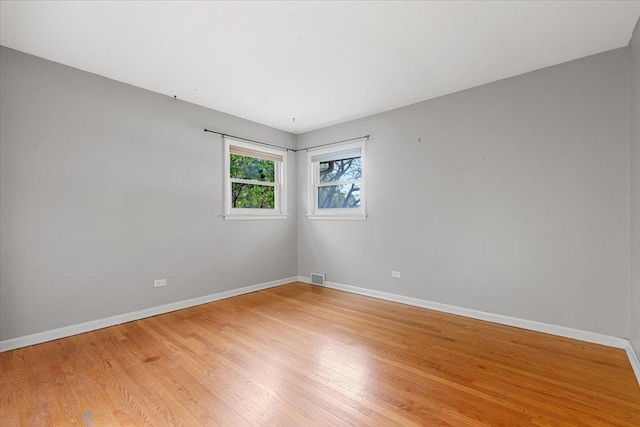 unfurnished room featuring hardwood / wood-style flooring