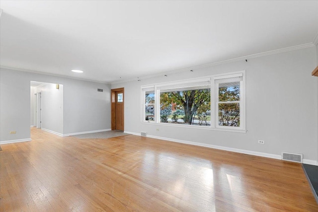 unfurnished living room with light hardwood / wood-style floors and ornamental molding