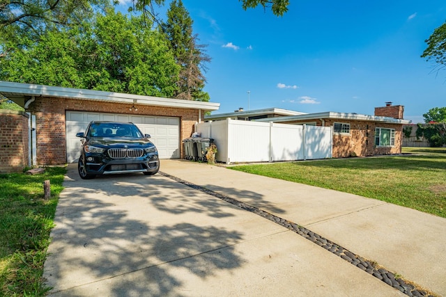 view of front of house with a garage and a front lawn