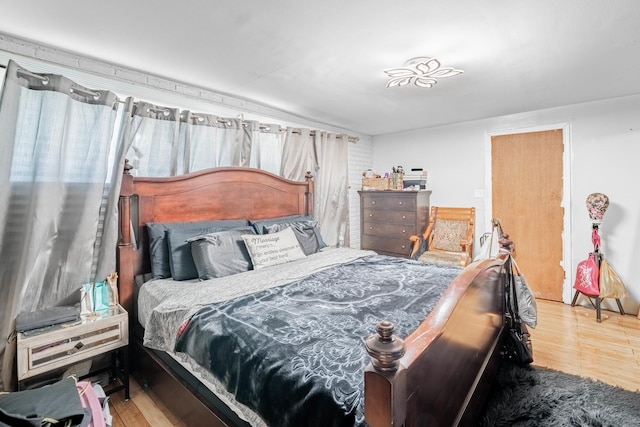 bedroom with hardwood / wood-style floors