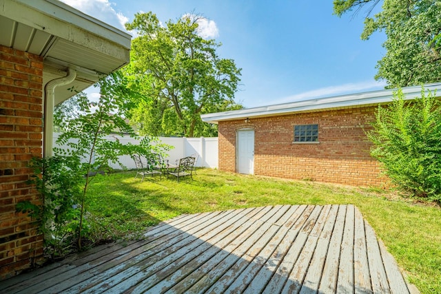 wooden deck with a lawn