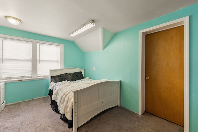 bedroom with carpet floors and lofted ceiling