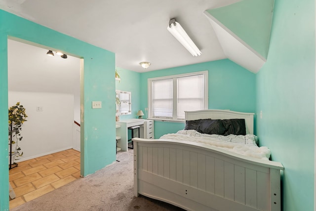 bedroom with light tile patterned floors and lofted ceiling